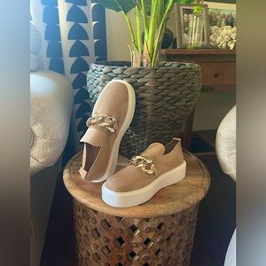 Brand new, never worn New Bella chic slide on sneakers with silver chain design.